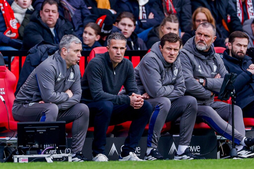 assistant coach Rene Hake of Feyenoord and head coach Robin van Persie of Feyenoord and assistant coach John de Wolf of Feyenoord looks on during the Dutch Eredivisie match between PSV Eindhoven and Feyenoord Rotterdam at Philips Stadion on February 1, 20